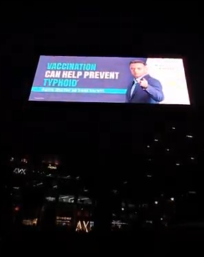 Typhoid Needs Attention digital billboard: vaccination can help prevent typhoid